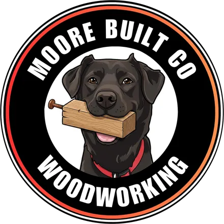 Moore Built Co Woodworking logo: a black lab carrying a block of wood